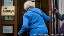 A woman enters a polling station after voting during snap elections in Vienna, Austria, on September 29, 2019. - Austria holds snap elections after a corruption scandal caused the dramatic collapse of the previous right-wing coalition government. (Photo by VLADIMIR SIMICEK / AFP) (Photo credit should read VLADIMIR SIMICEK/AFP/Getty Images)