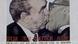 Graffiti art on the Berlin Wall of two men embracing Graffiti art on the Berlin Wall of two men embracing