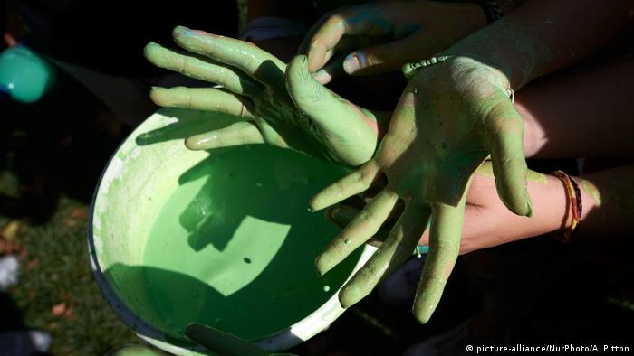 Green color on hands during climate protest