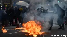 01.10.2019 *** Protesters throw Molotov cocktail after police fire tear gas to disperse protesters in Tsuen Wan district on October 1, 2019, as violent demonstrations take place in the streets of the city on the National Day holiday to mark the 70th anniversary of communist China's founding. - Strife-torn Hong Kong on October 1 marked the 70th anniversary of communist China's founding with defiant Day of Grief protests and fresh clashes with police as pro-democracy activists ignored a ban and took to the streets across the city. (Photo by Philip FONG / AFP)