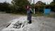 A woman stands on a bombed street in Eastern Ukraine A woman stands on a bombed street in Eastern Ukraine
