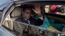05.10.2019 Cameroonian opposition leader Maurice Kamto (L) sits in the back of a car as he is driven away on October 5, 2019, in Yaounde, the day of his release from prison. - Cameroon's main opposition leader Maurice Kamto walked free from jail on October 5, 2019 after a military court ordered his release at the behest of veteran President Paul Biya. (Photo by STRINGER / AFP)