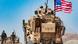 A US military vehicle near the Turkish border, with Syrian Kurds next to it A US military vehicle near the Turkish border, with Syrian Kurds next to it