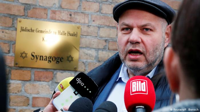 Max Privorozki bein interviewed by journalists outside the Halle synagogue
