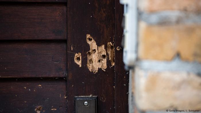 View of the entrance door to a synagogue in Halle that is ridden with bullet holes following an attempted attack