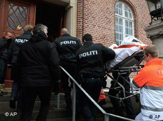 Danish police carry the suspect in an attack on a Danish cartoonist into court on a stretcher