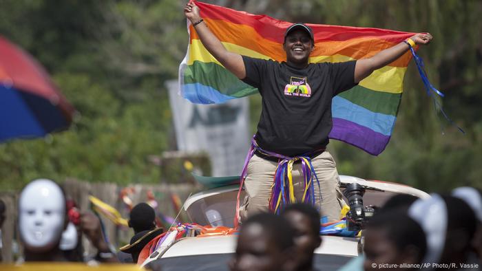 An LGBT supporter waves a rainbow flag at a parade