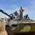 Soldiers with the Syrian Army pose on a tank ARCHIV