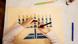 A Jewish child draws a Hanukkah light A Jewish child draws a Hanukkah light