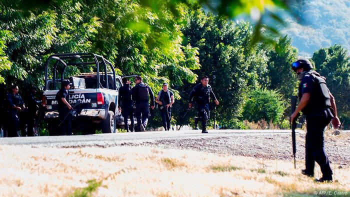 Police officers are seen after gunmen killed 14 policemen and torched at least two of their vehicles in an ambush in the community of Aguililla, in the Mexican state of Michoacan, 