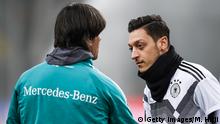 DUESSELDORF, GERMANY - MARCH 22: Head coach Joachim Loew talks to Mesut Oezil during a Germany training session ahead of their international friendly match against Spain at ESPRIT arena on March 22, 2018 in Duesseldorf, Germany. (Photo by Maja Hitij/Bongarts/Getty Images)