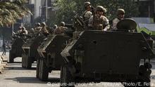 Army armored vehicles patrol the streets, after a night of riots that forced President Sebastian Pinera to announce a state of emergency, in Santiago, Chile, Saturday, Oct. 19, 2019. The protests started on Friday afternoon when high school students flooded subway stations, jumping turnstiles, dodging fares and vandalizing stations as part of protests against a fare hike, but by nightfall had extended throughout Santiago with students setting up barricades and fires at the entrances to subway stations. (AP Photo/Esteban Felix) |