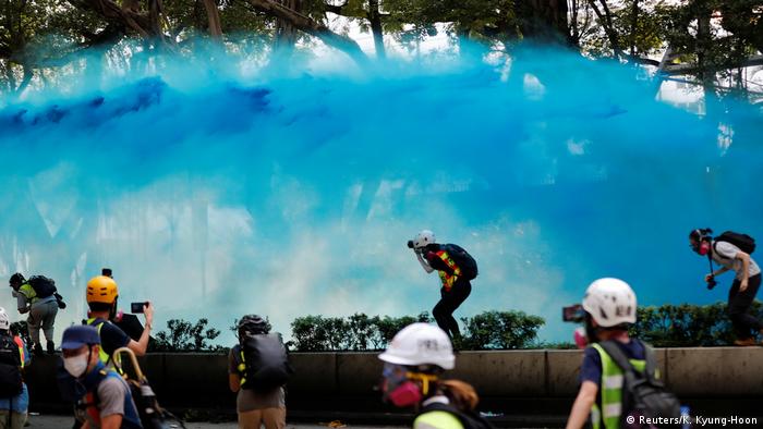A water cannon filled with blue dye is deployed by police in Hong Kong