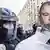 Поліцейський біля зображення Олега Гладковського на одній з акцій протесту в березні 2019 року