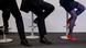 Executives sit crosslegged on stools Executives sit crosslegged on stools