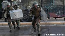 Riot policemen run during anti-government protests in Santiago, Chile October 29, 2019. REUTERS/Edgard Garrido