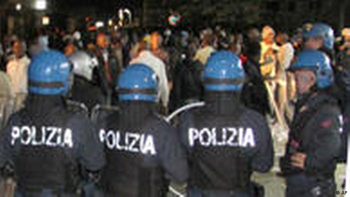 Italian police in riot gear are seen engaging a group of immigrant workers in the streets of Rosarno, near Reggio Calabria, southern Italy