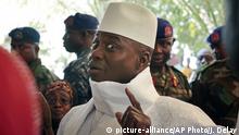 FILE - In this Thursday, Dec. 1, 2016 file photo, Gambia's President Yahya Jammeh shows his inked finger before voting in Banjul, Gambia. Gambia's ex-President Yahya Jammeh looted the tiny West African nation of $1 billion through fear and privilege during his 22 years in power, an amount more than 10 times higher than originally estimated by the new government, leaving the country in lingering debt, according to a report on Wednesday March 27, 2019, by the investigative group Organized Crime and Corruption Reporting Project. (AP Photo/Jerome Delay, File) |