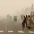 People walk on the Rajpath on a smoggy day in New Delhi