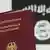 A German passport with an IS flag in the background
