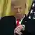 US president Trump looks at his watch