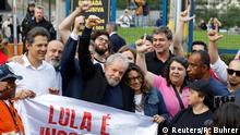 Former Brazilian President Luiz Inacio Lula da Silva gestures behind a banner reading Lula is innocent after being released from prison, in Curitiba, Brazil November 8, 2019. REUTERS/Rodolfo Buhrer