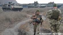 09.11.2019 *** Servicemen of the Ukrainian armed forces get ready to ride armored personnel carriers (APC) in the settlement of Bohdanivka, which is located in a disengagement area near the contact line with Russian-backed separatist rebels, in Donetsk Region, Ukraine November 9, 2019. REUTERS/Oleksandr Klymenko