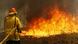 Firefighters work to contain a bushfire in Old Bar, Australia Firefighters work to contain a bushfire in Old Bar, Australia