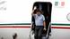 Morales waves aas he steps down from the plane Morales waves aas he steps down from the plane