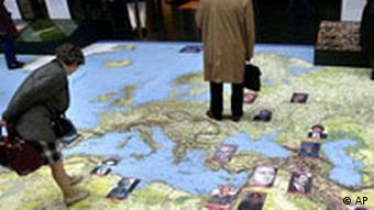 People look at portraits of dictators displayed on a giant map by Reporters Without Borders for the twelfth international Press Freedom Day at the Saint Lazare station in Paris, Friday May 3, 2002.