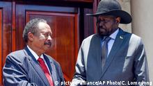 President Salva Kiir of South Sudan, right, welcomes Prime Minister of Sudan Abdallah Hamdok at the State House in Juba, South Sudan, Thursday, Sept. 12, 2019. Hamdok arrived in Juba, South Sudan to join the Sudanese peace process between opposition parties. (AP Photo/Charles Atiki Lomodong)
