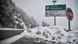 Road signs on road covered in snow Road signs on road covered in snow