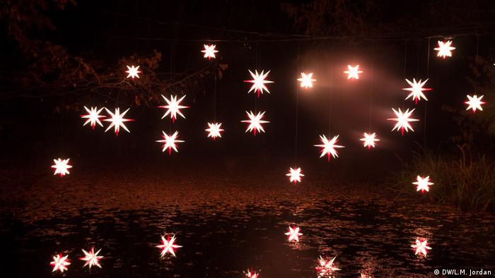 Christmas Garden Berlin 2019, Christmas lights suspended over a pond (DW/L.M. Jordan)