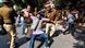 Security personnel hold a Jawaharlal Nehru University (JNU) student during a students protest against accommodation fee hike, as security measures have been reinforced from JNU campus along the road to the march protest, in New Delhi on November 18, 2019 Security personnel hold a Jawaharlal Nehru University (JNU) student during a students protest against accommodation fee hike, as security measures have been reinforced from JNU campus along the road to the march protest, in New Delhi on November 18, 2019