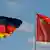 German and Chinese flags wave in the wind in Berlin, Germany