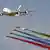 An Airbus A380-800 passenger plane (L) and the Al Fursan [Knights] UAE Air Force aerobatic display team perform at the 2019 Dubai Airshow.