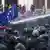 Protester with EU flag hit by water cannon