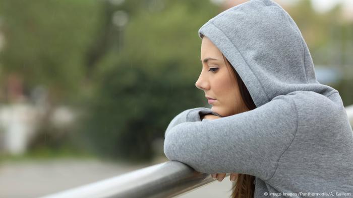 Young woman looks out over a bridge Young woman looks out over a bridge