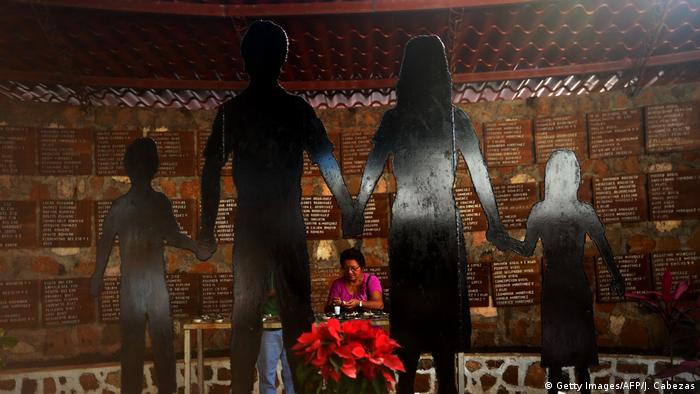 Foto de una persona en el monumento a las víctimas de El Mozote, en El Salvador
