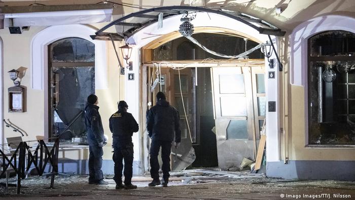 Police investigate damage to a nightclub where a bomb detonated in central Malmo in March