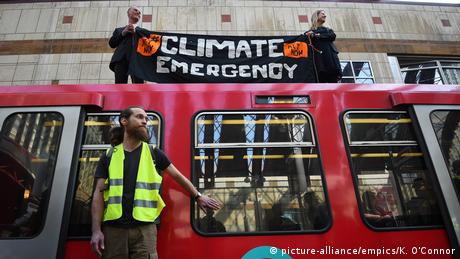 Extinction Rebellion protesters glue themselves to a train in London 