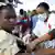 A nurse treats a young quake survivor