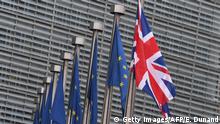 TOPSHOT - This photo taken on December 4, 2017 shows the British flag displayed next to flags of the European Union in front of the European Union Commission in Brussels. British Prime Minister Theresa May is set to meet key European Union figures for talks on Brexit which could determine whether the UK is able to move on to negotiations on trade. / AFP PHOTO / EMMANUEL DUNAND (Photo credit should read EMMANUEL DUNAND/AFP via Getty Images)