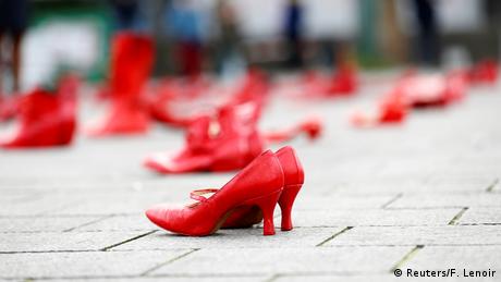Red shoes on pavement (Reuters/F. Lenoir)