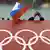 A Russian flag held near a sign featuring the Olympic Rings (AP Photo/David J. Phillip, File)