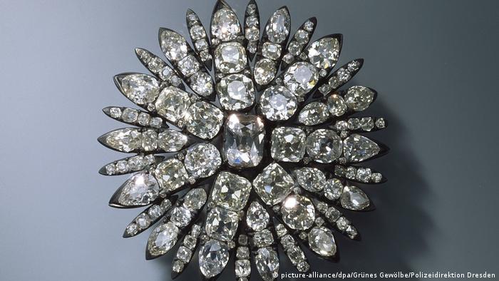 A circular hair decoration in the shape of a circle covered in diamonds and made of silver 