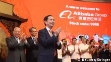 Alibaba's Chairman and Chief Executive Officer Daniel Zhang, Hong Kong Financial Secretary Paul Chan and former Hong Kong chief executive Tung Chee-hwa attend Alibaba Group's listing ceremony at the Hong Kong Stock Exchange (HKEX) in Hong Kong, China November 26, 2019. REUTERS/Stringer ATTENTION EDITORS - THIS IMAGE WAS PROVIDED BY A THIRD PARTY. CHINA OUT.