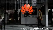 A woman walks past the logo of Chinese telecom giant Huawei during the Web Summit in Lisbon on November 6, 2019. - Europe's largest tech event Web Summit is held at Parque das Nacoes in Lisbon from November 4 to November 7. (Photo by PATRICIA DE MELO MOREIRA / AFP) (Photo by PATRICIA DE MELO MOREIRA/AFP /AFP via Getty Images)