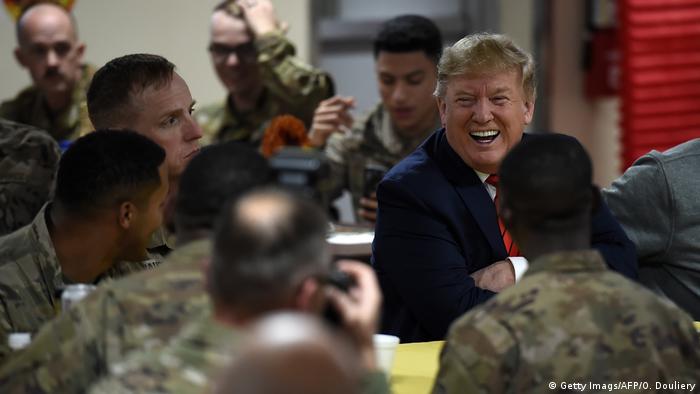 US President Donald Trump serves Thanksgiving dinner to US troops at Bagram Air Field during a surprise visit on November 28, 2019 in Afghanistan.