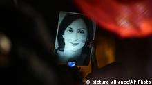 A protester holds up a picture of murdered reporter Daphne Caruana Galizia on the fourth day of a demonstration outside Malta's prime minister's office in Valletta, Malta, Wednesday, Nov. 27, 2019. On Wednesday Maltese police arrested Prime Minister Joseph Muscat’s former chief of staff Keith Schembri for questioning as a person of interest in the murder of the journalist. (AP Photo/Str) |
